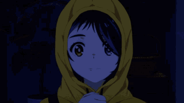 a girl with two different colored eyes is wearing a yellow hood