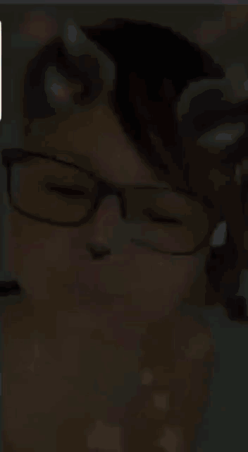a girl wearing glasses and cat ears looks like a cat