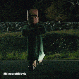 a car is driving down a road at night with a #minecraftmovie watermark