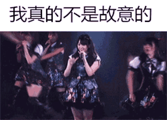 a woman singing into a microphone on a stage with chinese writing