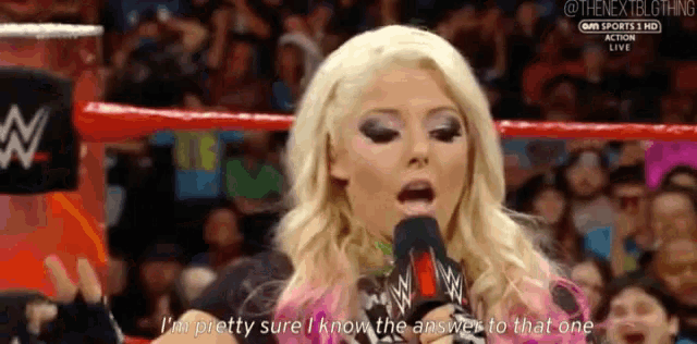 a woman in a wrestling ring is speaking into a microphone and says i 'm pretty sure i know the answer