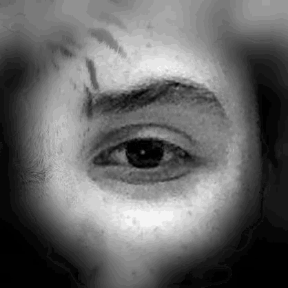 a black and white photo of a person 's eye with a blurred background .