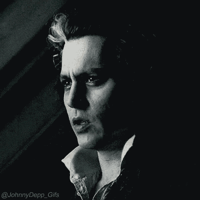 a close up of a man 's face in a dark room