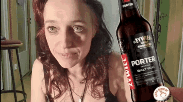 a woman is standing next to a bottle of porter beer