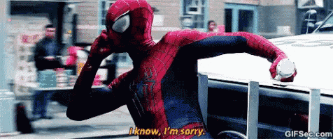 a spider man is talking on a cell phone and says i know i 'm sorry .