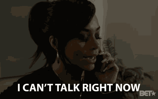 a woman talking on a cell phone with the words " i can 't talk right now " beneath her