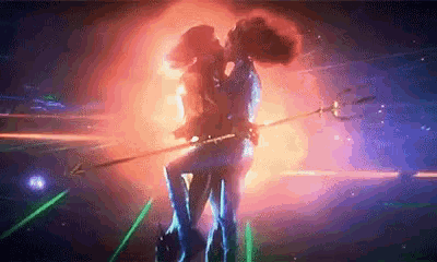 a couple of people are kissing in a dark room with a trident in their hand .