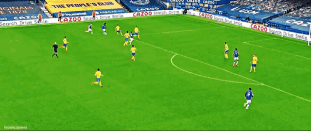 a soccer game is being played in front of a crowd with a banner for cazoo