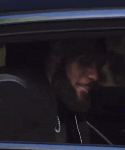 a close up of a car window with a reflection of a person in it .