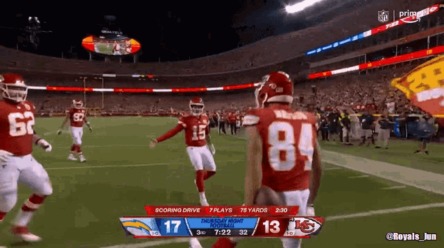 a football player with the number 84 on his jersey is running on the field