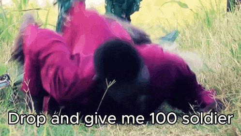 a person laying in the grass with the words drop and give me 100 soldier written below them
