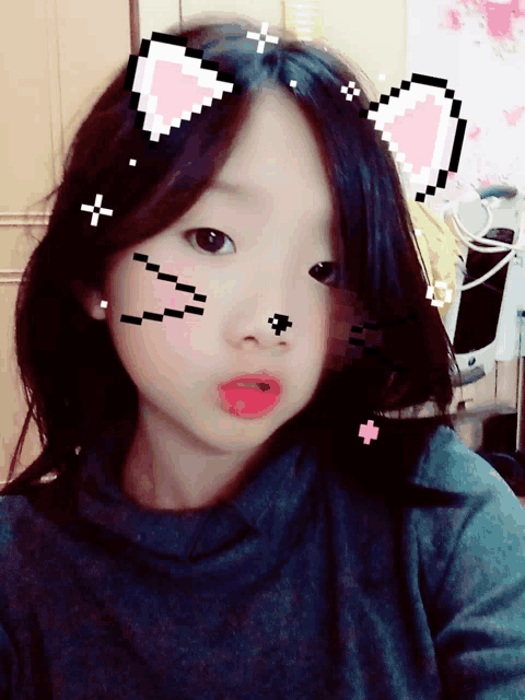 a little girl with pixelated cat ears on her hair looks at the camera