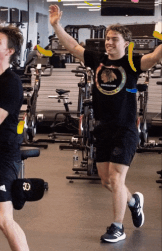 a man wearing a black shirt that says chicago blackhawks is running in a gym
