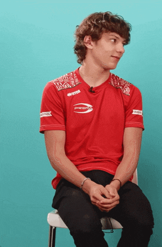 a young man wearing a red shirt that says powerade on it