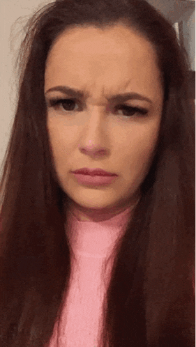 a woman with long red hair is making a funny face