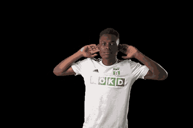 a man wearing a white shirt that says rokd