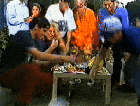 a group of people gathered around a table with plates of food