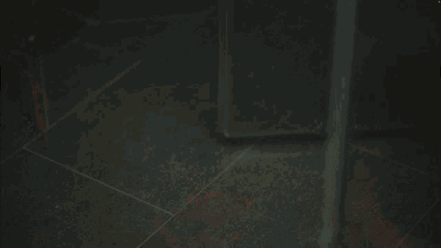 a man without a shirt is taking a shower in a dark room