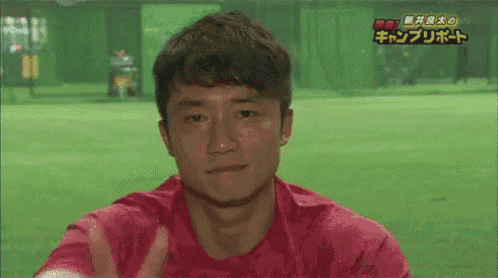 a man in a red shirt is giving a high five