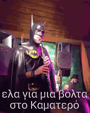 a man dressed as batman playing a clarinet