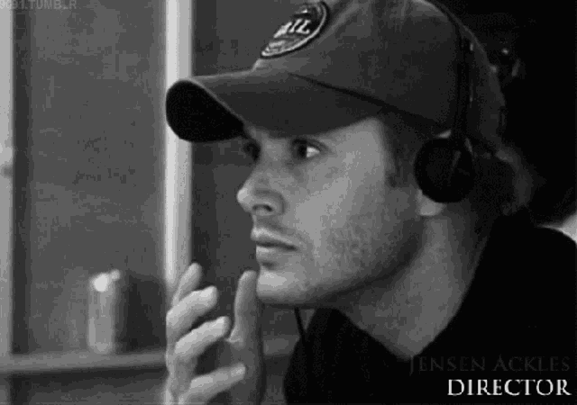 a man wearing a baseball cap and headphones is a director