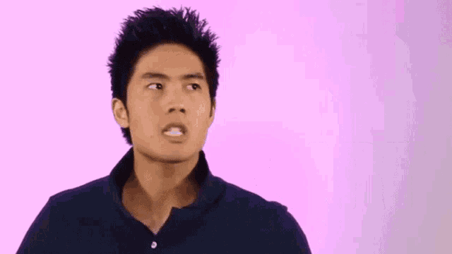 a man is standing in front of a pink background with the word smart in blue