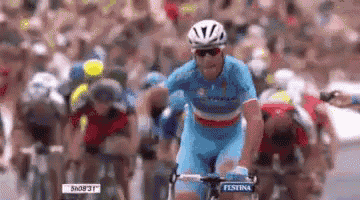 a man is riding a bike with the word festina on the front of his shirt