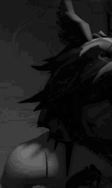 a black and white photo of a person wearing a mask with horns on their head .