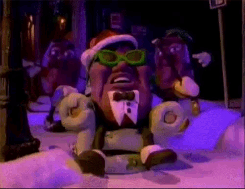 a cartoon character wearing a santa hat and sunglasses is sitting in the snow