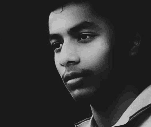 a black and white photo of a young man