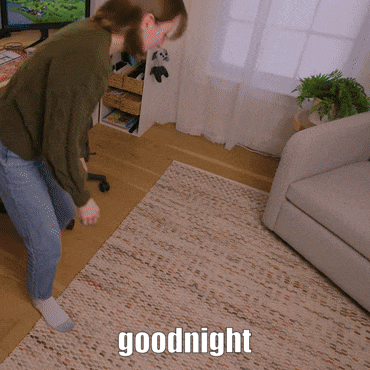 a woman is standing on a rug with the words goodnight written on it