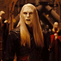a man with long blonde hair is wearing a black leather jacket