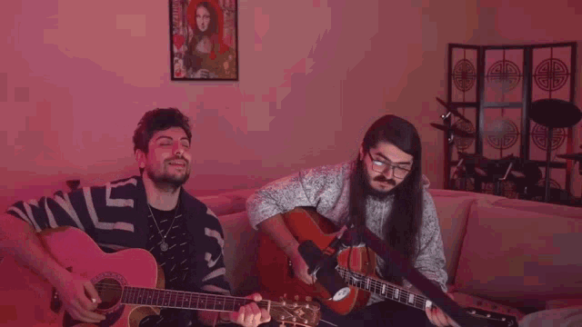 two men are playing guitars in front of a pink wall with a purple border that says ' joinsinemalari ' on it