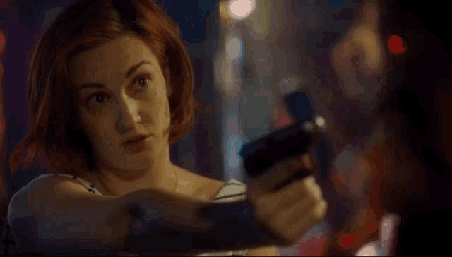 a woman holding a gun with the words how smart am i i 'm smart above her
