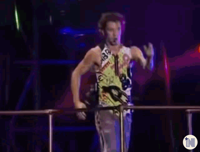 a blurry photo of a man singing with the letter n in the corner