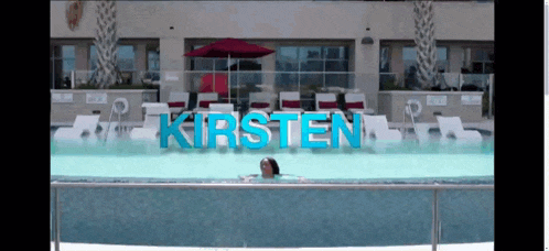 a woman is swimming in a pool with the name kirsten written on it
