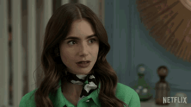 a woman wearing a green shirt says okay in front of a netflix logo