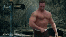 a man without a shirt is standing in a cave with the words male brotherhood on the bottom right