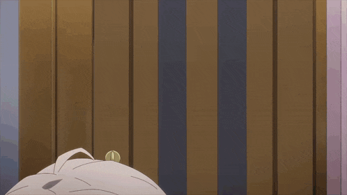 a cartoon character laying on a bed with a striped wall behind them