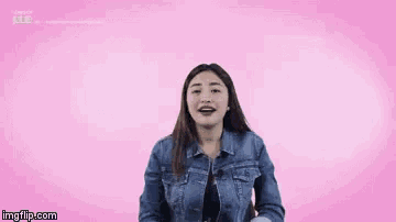 a woman in a denim jacket with her arms wide open