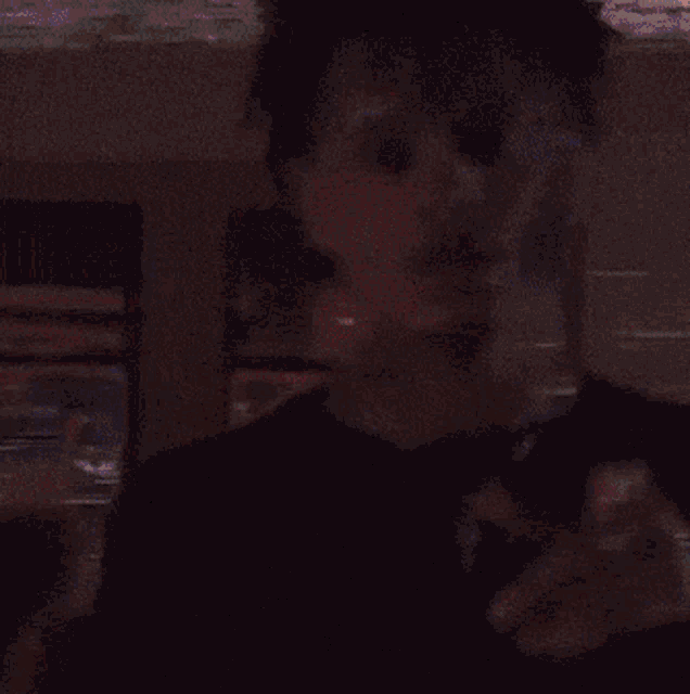 a blurry picture of a person with blue and pink lights projected on his face
