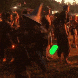 a man is doing a handstand in front of a crowd of people .