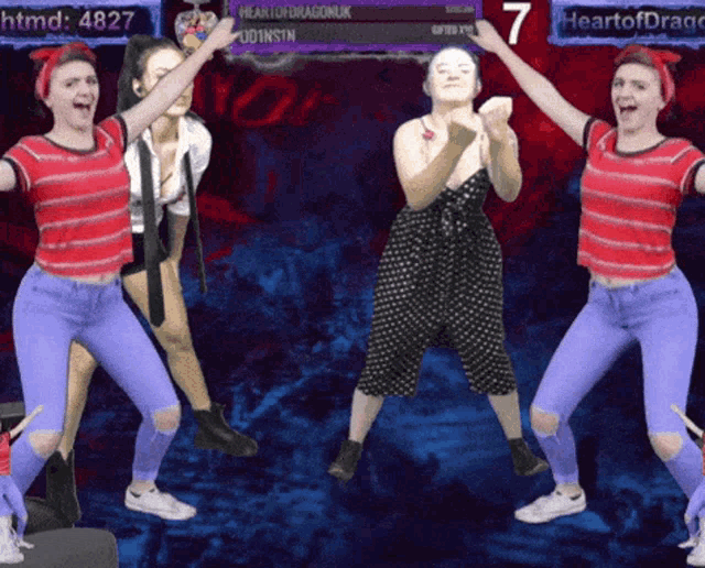 a group of women are dancing in front of a scoreboard that says heart of dragonuk