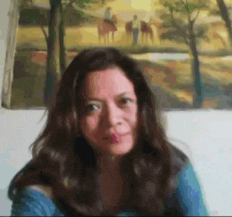 a blurry picture of a woman in front of a painting of people on horses