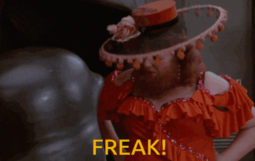 a woman in a red dress is kissing a man in a hat and the words freak are visible