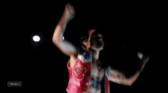 a man without a shirt is dancing with his arms in the air