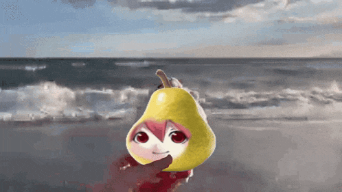 a person is holding a pear with a face on it in front of the ocean
