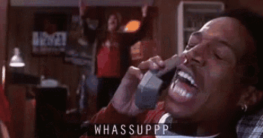 a man is yawning while talking on a telephone with his mouth open .