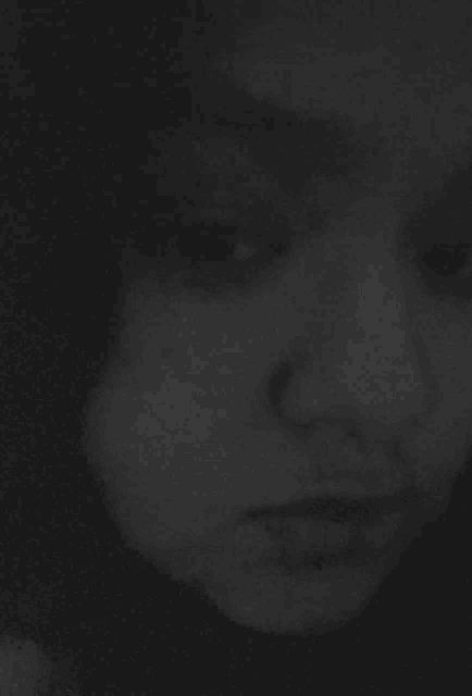 a black and white image of a person 's face