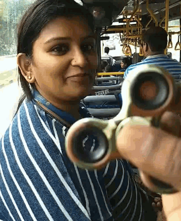a woman holds a fidget spinner in front of her face